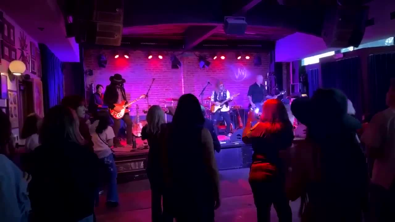 A fan filming the stage on a phone